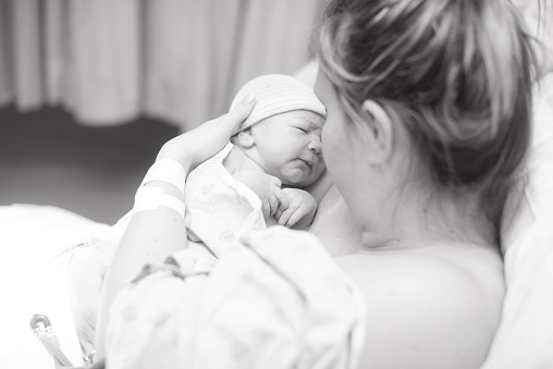 a newly born baby with his mother.