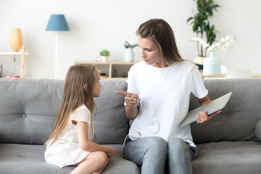 strict mother scolding little daughter for long laptop use